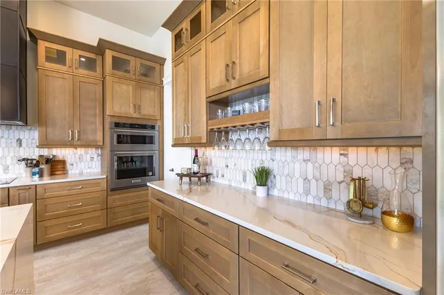 a kitchen with stainless steel appliances a sink and cabinets