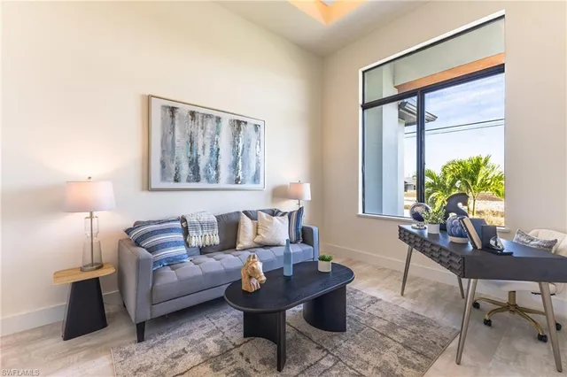 a living room with furniture and a potted plant