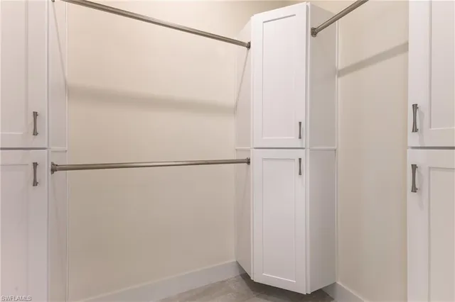 a bathroom with a double vanity sink a toilet a mirror and bathtub