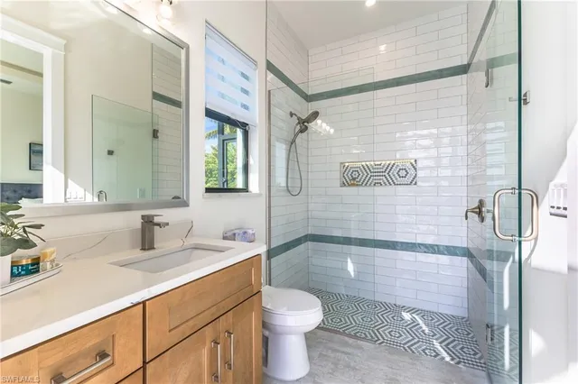 a bathroom with a sink toilet and mirror