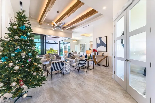 a living room with patio furniture and a potted plant