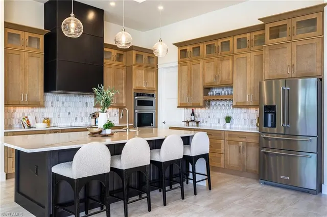a kitchen with a table chairs sink and cabinets
