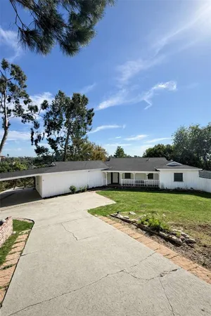 a view of a house with a yard and a garage