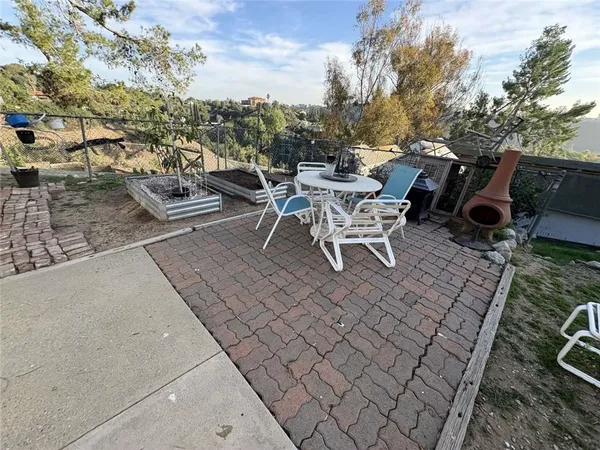 a view of a patio with table and chairs and couches