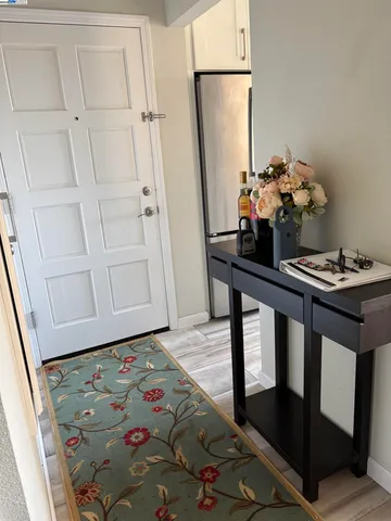 a view of hallway with furniture and a potted plant
