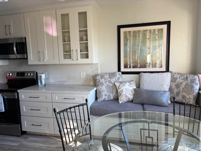 a living room with furniture a flat screen tv and a window