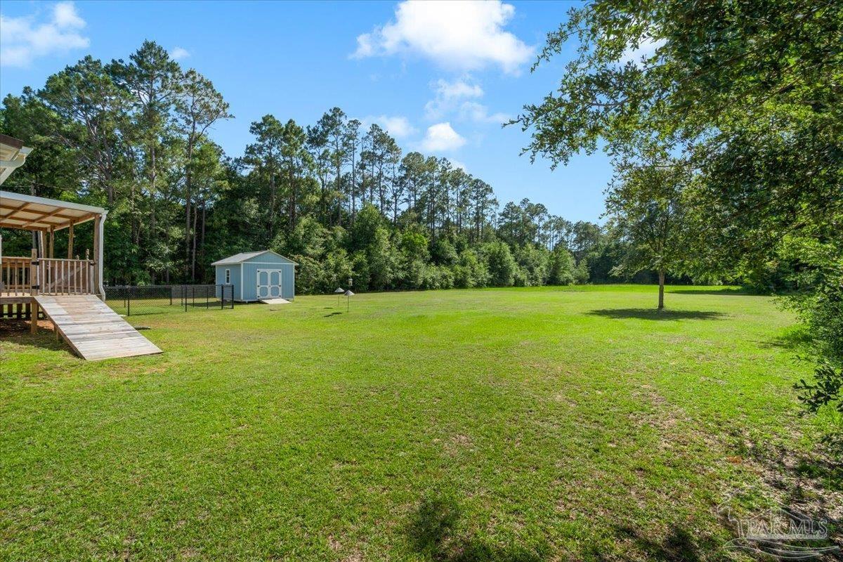 4955 Blue Ribbon Drive Milton, FL 32583 - Photo 29 of 32 a view of a house with a backyard