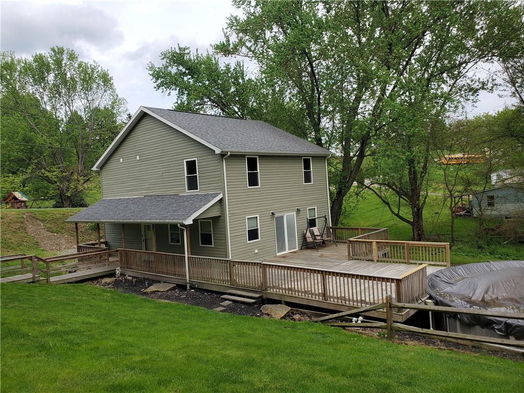 a view of backyard with deck and garden