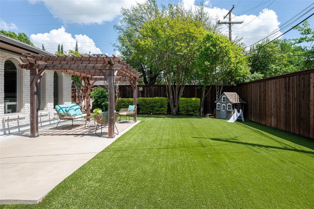 3352 Princess Lane Dallas, TX 75229 - Photo 23 of 28 Turfed backyard with patio and pergola