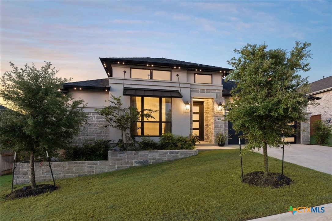 a front view of a house with a yard