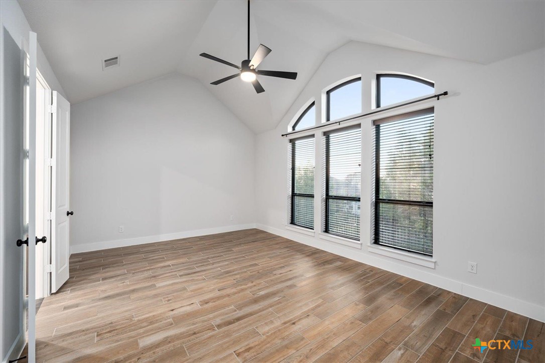 412 Pin Cherry Pass San Marcos, TX 78666 - Photo 12 of 27 wooden floor in an empty room with a window
