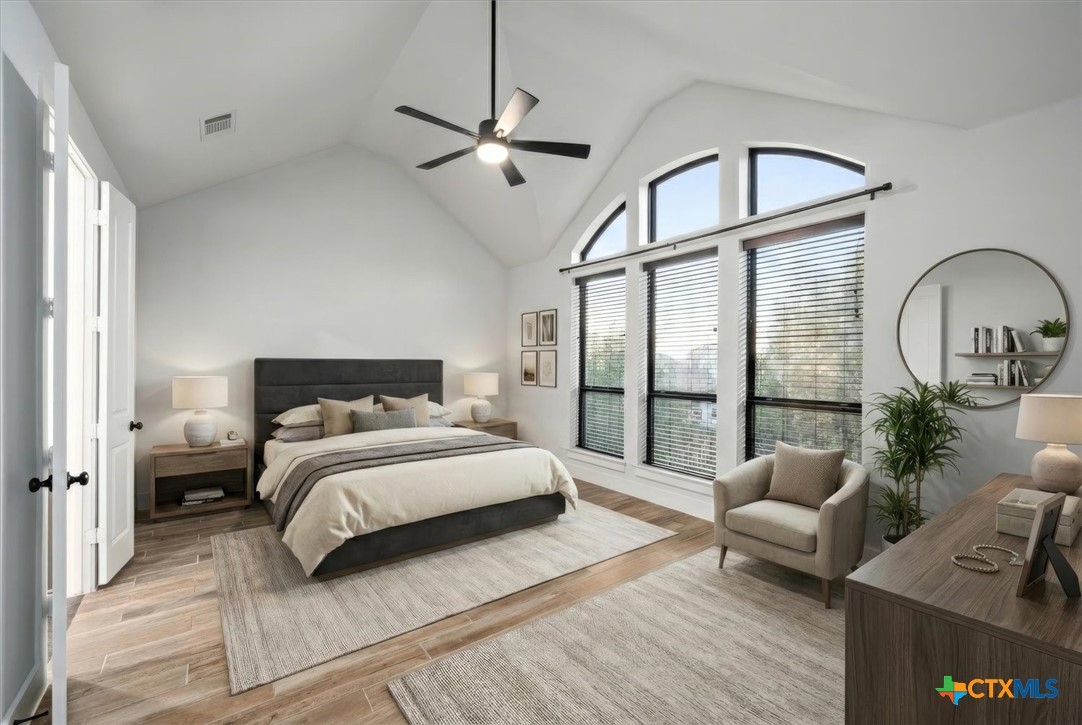 412 Pin Cherry Pass San Marcos, TX 78666 - Photo 13 of 27 a spacious bedroom with a bed couch and a window