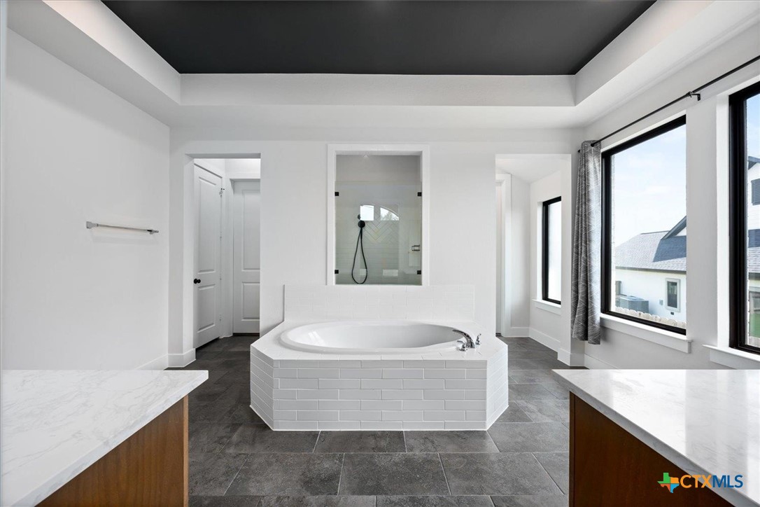 412 Pin Cherry Pass San Marcos, TX 78666 - Photo 14 of 27 a spacious bathroom with a tub and sink