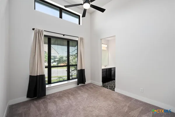 an empty room with windows and closet