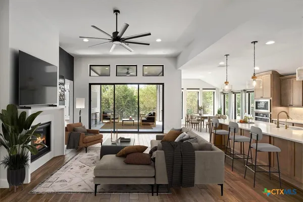 a living room with furniture a flat screen tv and a large window