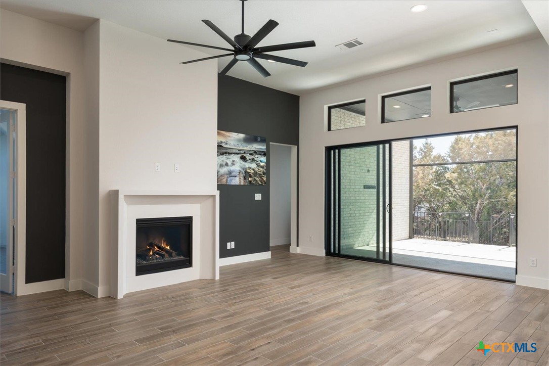 412 Pin Cherry Pass San Marcos, TX 78666 - Photo 6 of 27 a view of an empty room with a fireplace and a window