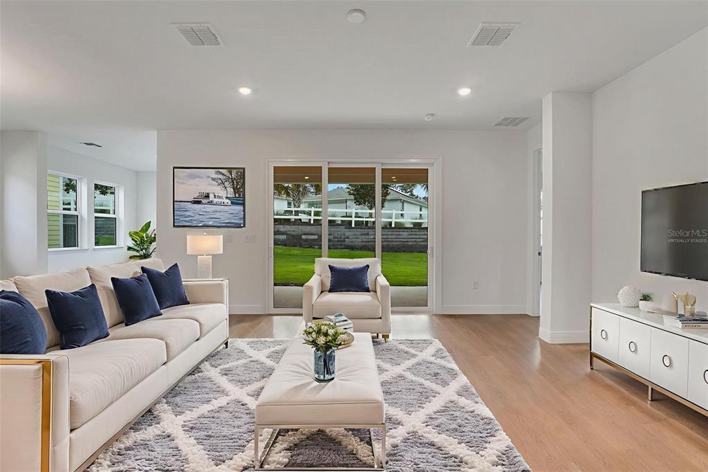 987 Fiesta Key Circle Lady Lake, FL 32159 - Photo 12 of 39 a living room with furniture and a flat screen tv