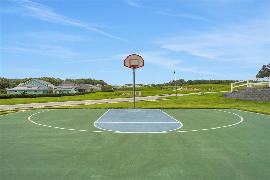987 Fiesta Key Circle Lady Lake, FL 32159 - Photo 22 of 39 a view of a tennis court