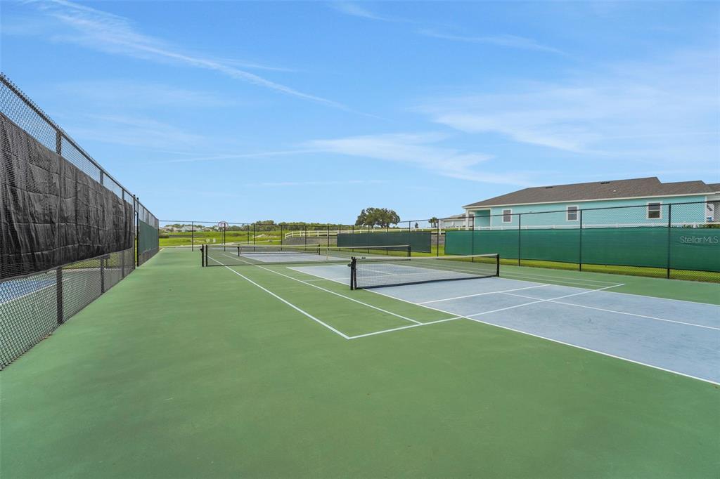 987 Fiesta Key Circle Lady Lake, FL 32159 - Photo 23 of 39 a view of a tennis court