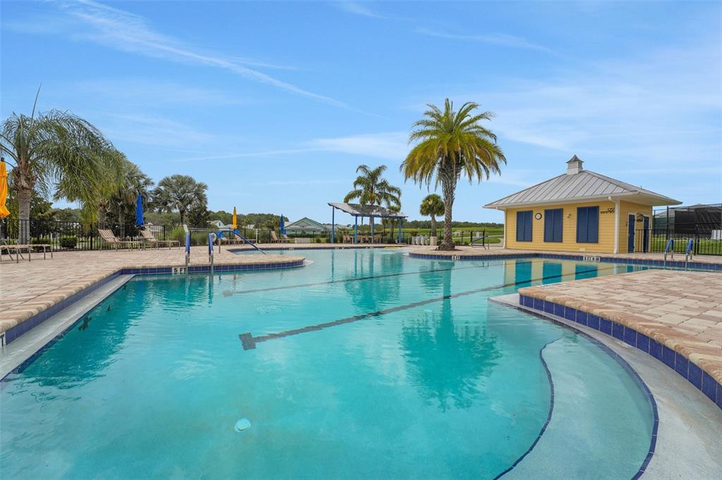 987 Fiesta Key Circle Lady Lake, FL 32159 - Photo 26 of 39 a swimming pool with outdoor seating and yard