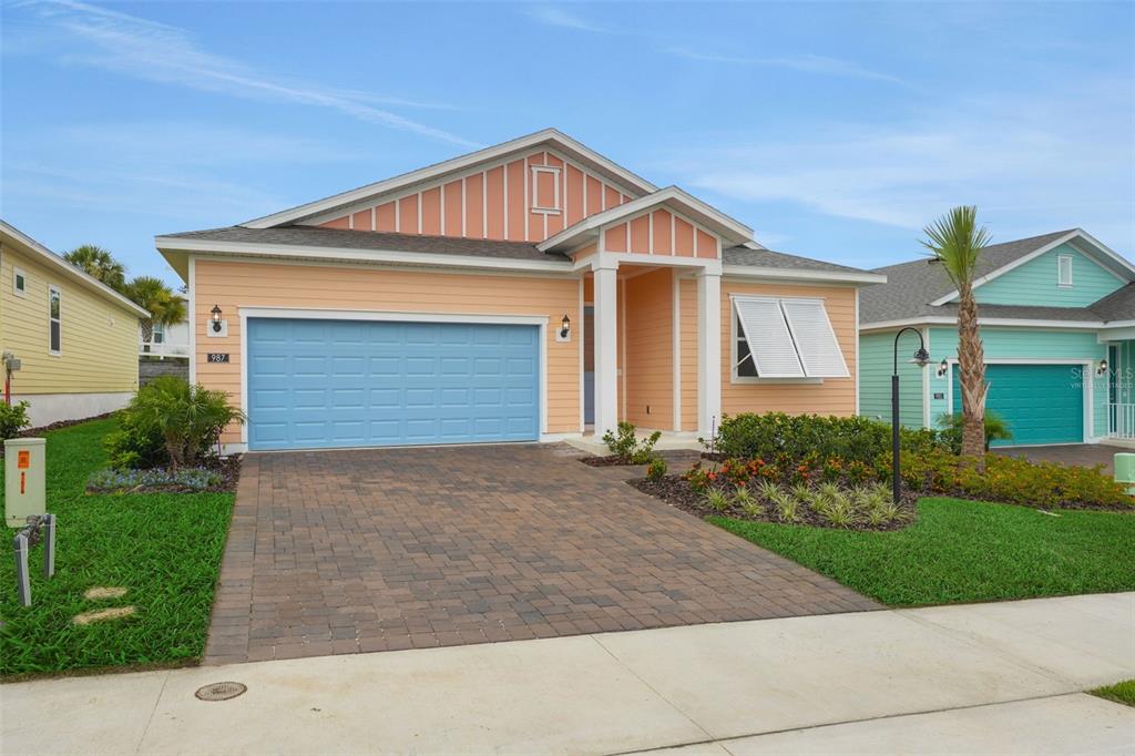 987 Fiesta Key Circle Lady Lake, FL 32159 - Photo 3 of 39 a front view of a house with a yard and garage
