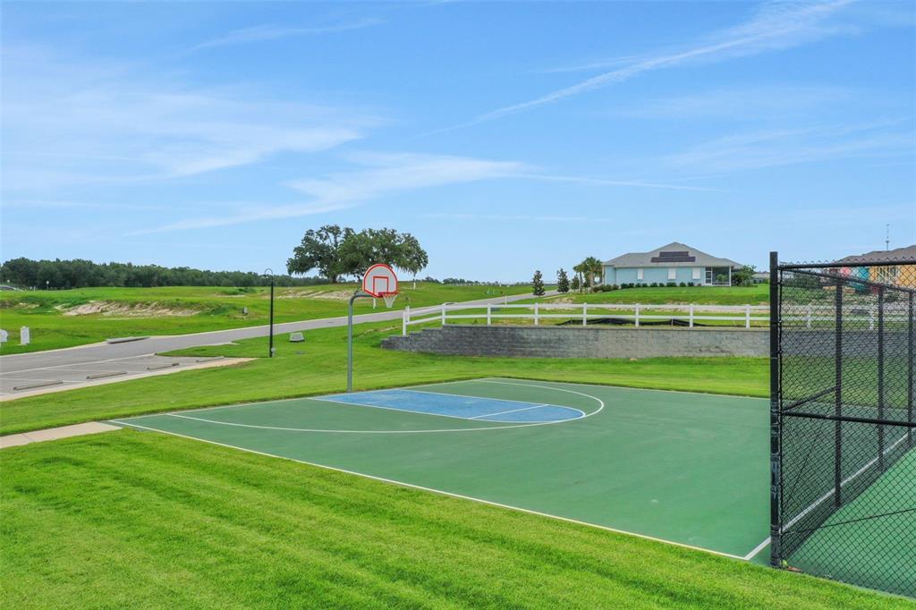 987 Fiesta Key Circle Lady Lake, FL 32159 - Photo 31 of 39 a view of a tennis court
