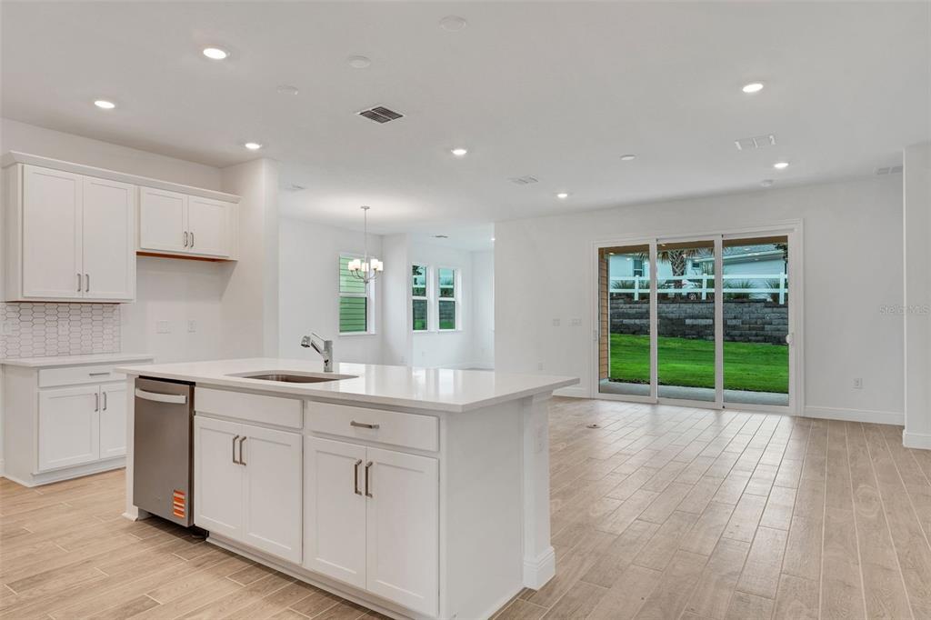 987 Fiesta Key Circle Lady Lake, FL 32159 - Photo 5 of 39 a kitchen with a sink window and wooden floor