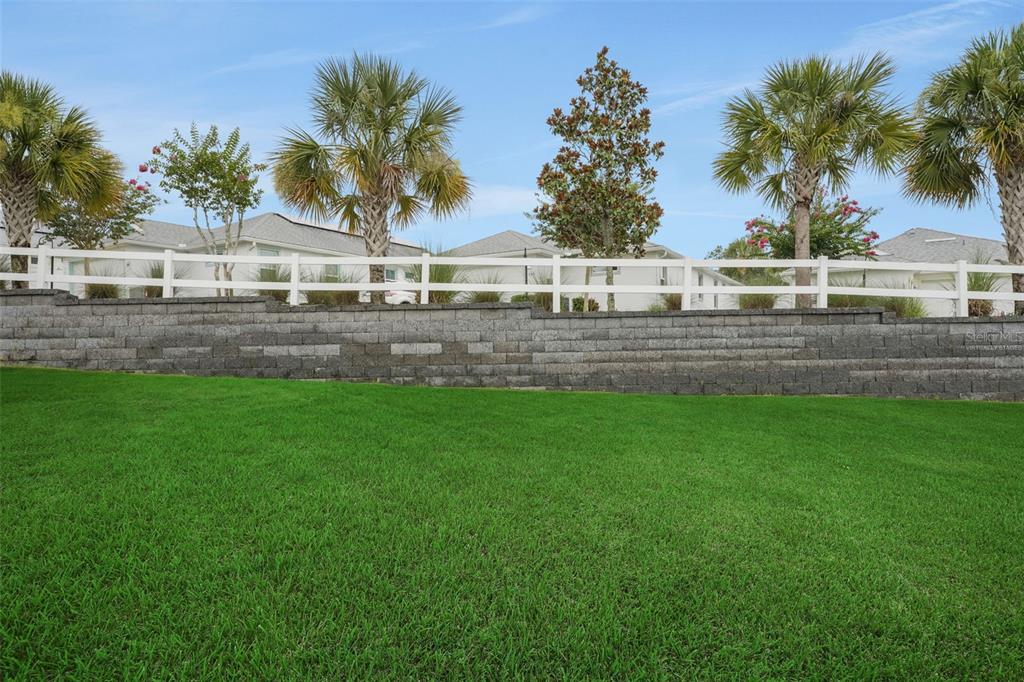 987 Fiesta Key Circle Lady Lake, FL 32159 - Photo 6 of 39 a view of house with a big yard and palm trees