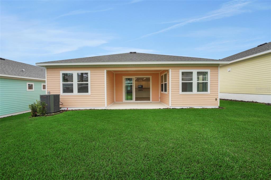 987 Fiesta Key Circle Lady Lake, FL 32159 - Photo 8 of 39 a view of a house with backyard