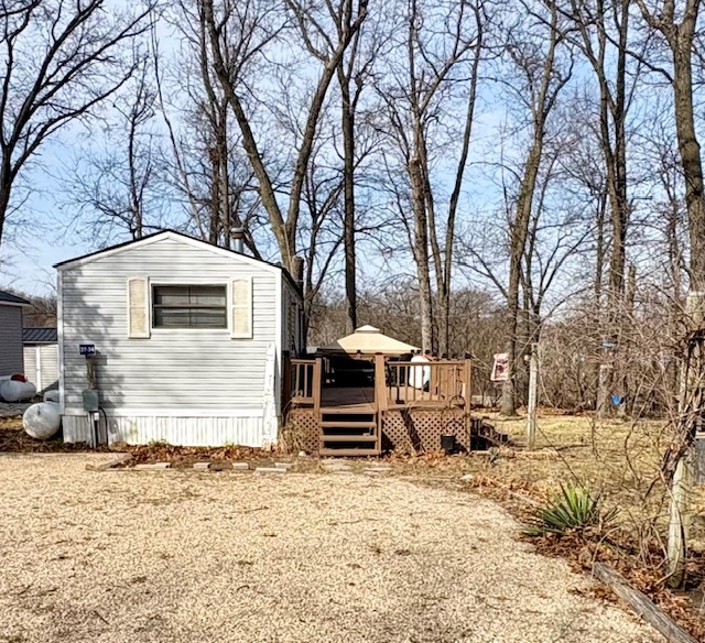 27-34 Woodhaven Sublette, IL 61367 - Photo 1 of 17 a front view of a house with a yard covered with snow