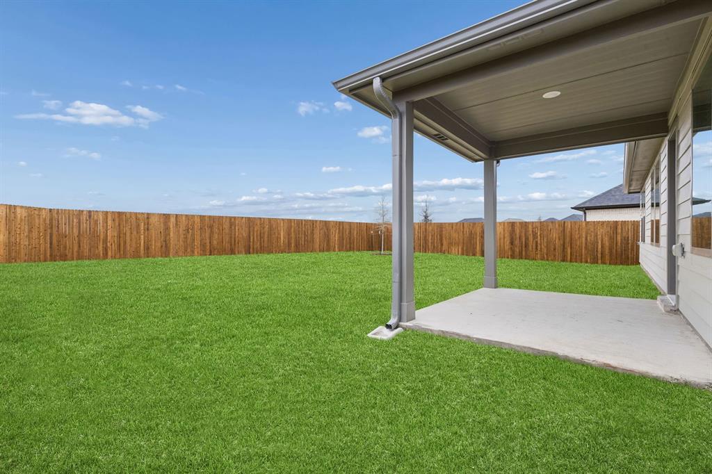 1124 Del Rio Drive Lavon, TX 75166 - Photo 29 of 32 Covered Patio in the Emmy II home plan by Trophy Signature Homes - REPRESENTATIVE PHOTO
