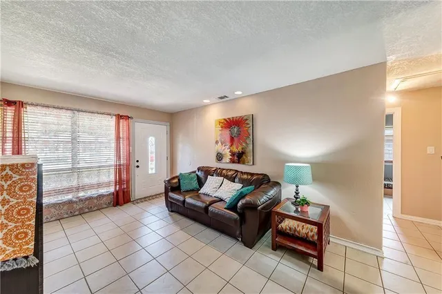 a living room with furniture and a floor to ceiling window