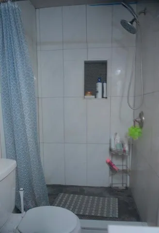 a bathroom with a toilet and a shower