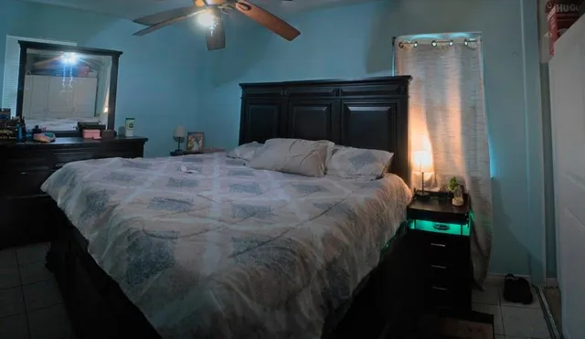 a view of a workspace with furniture and a fan
