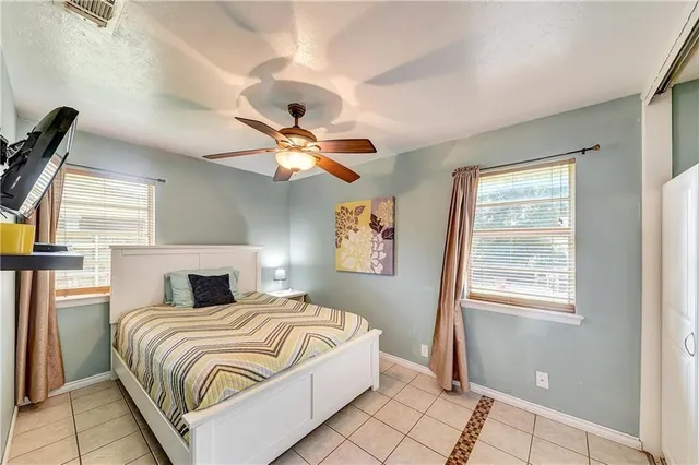 a bedroom with a large bed and a window