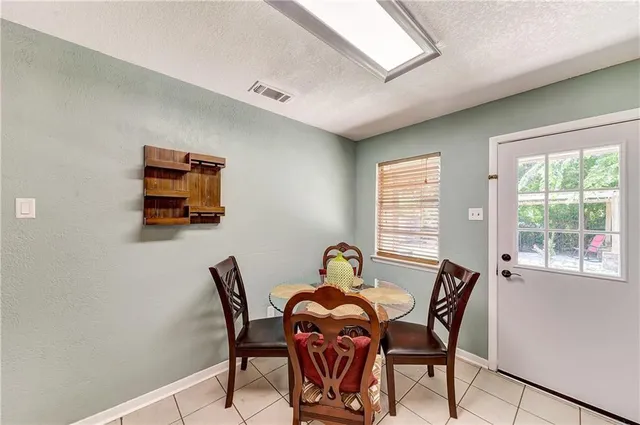 a dining room with furniture and window