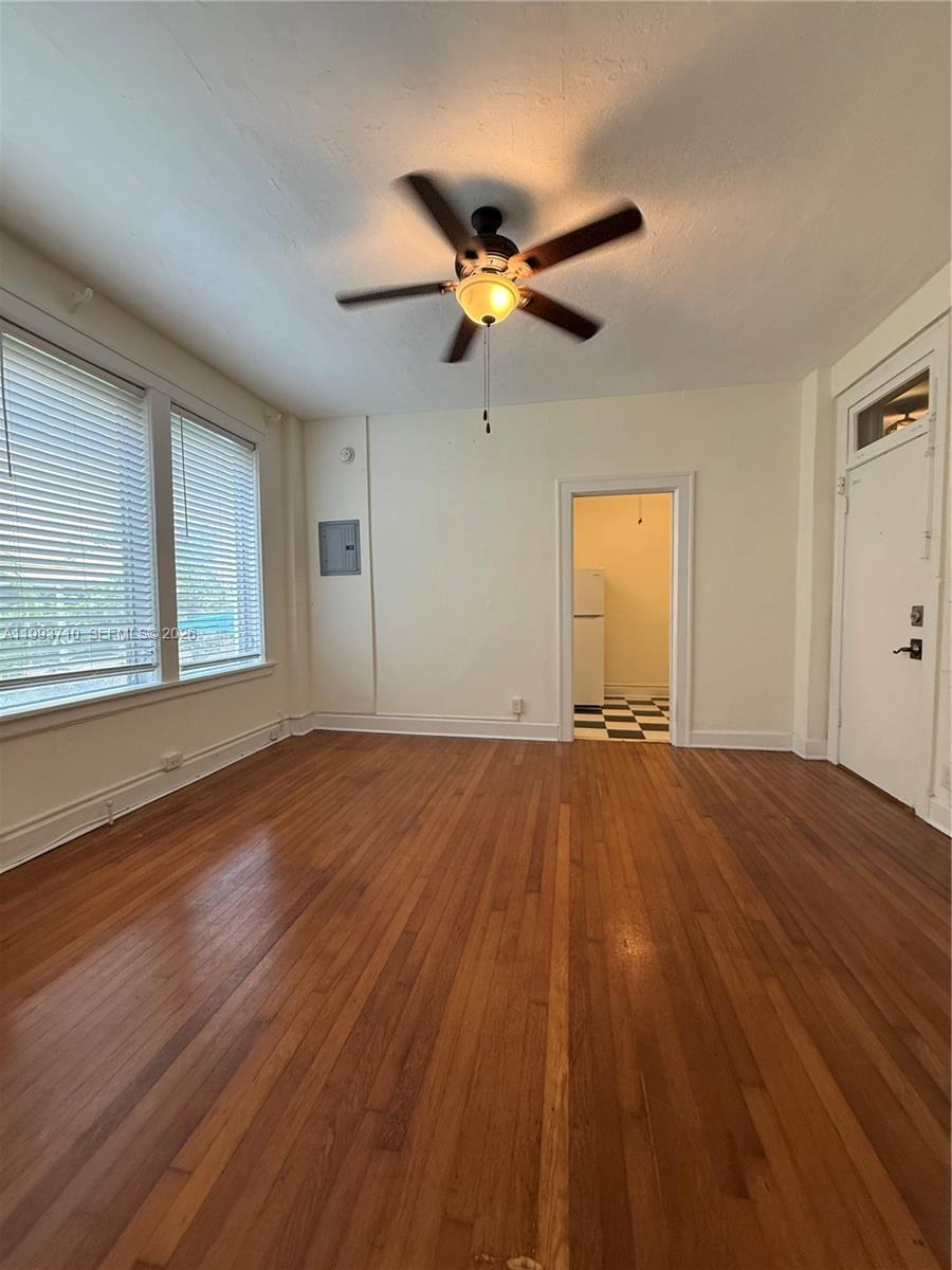 1361 Meridian Avenue, Unit 4 Miami Beach, FL 33139 - Photo 13 of 14 a view of empty room with wooden floor and fan