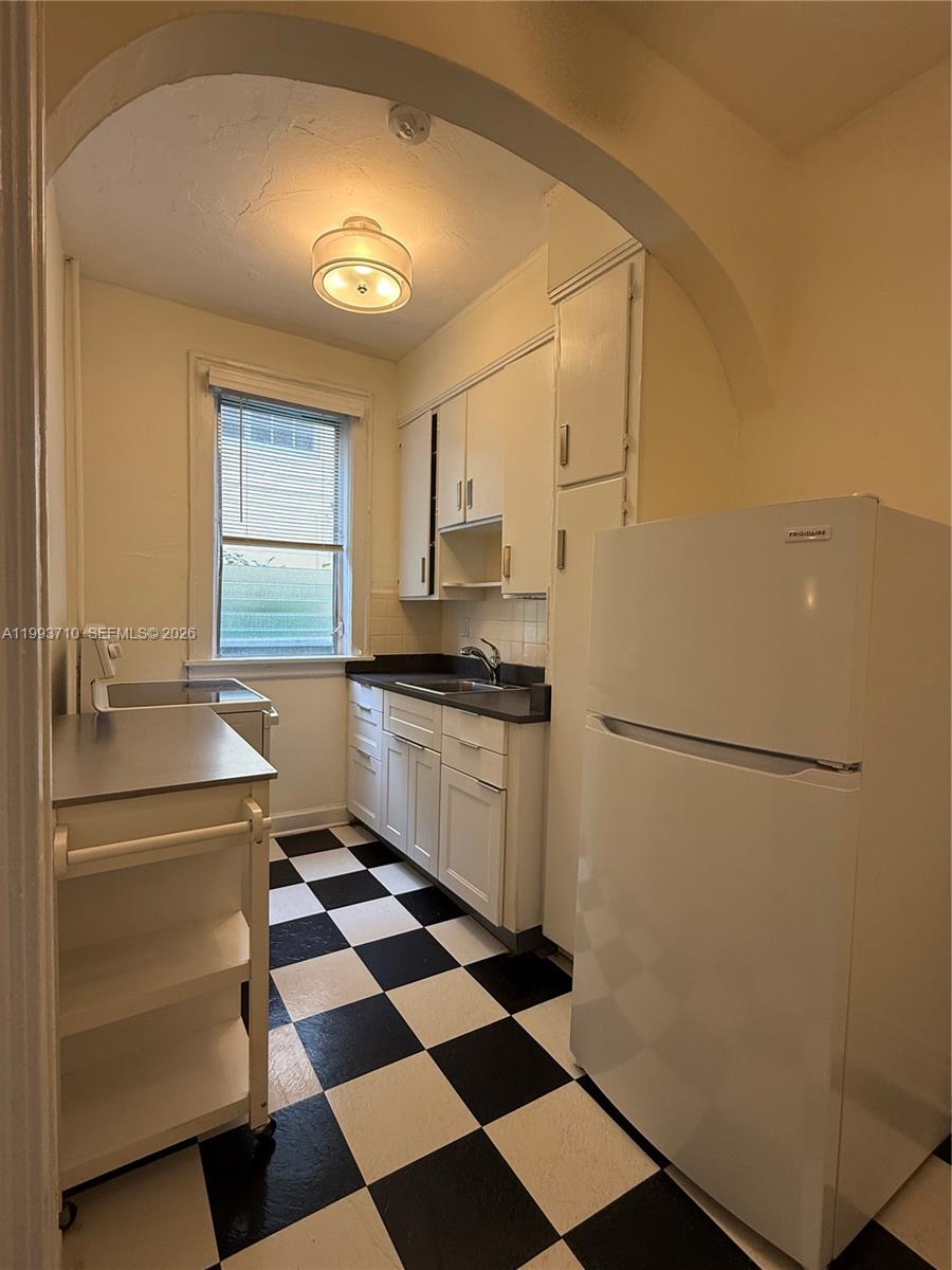 1361 Meridian Avenue, Unit 4 Miami Beach, FL 33139 - Photo 10 of 14 a kitchen with a refrigerator a sink and a cabinets