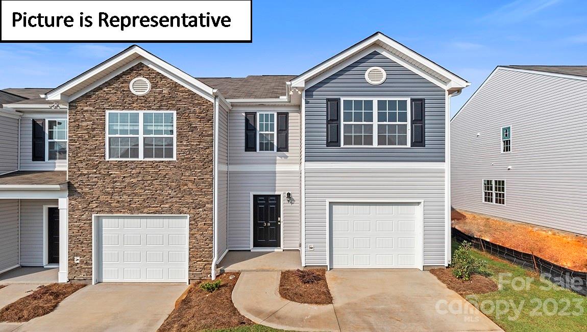 7113 North Mill Road Charlotte, NC 28216 - Photo 1 of 26 a front view of a house with a yard and garage