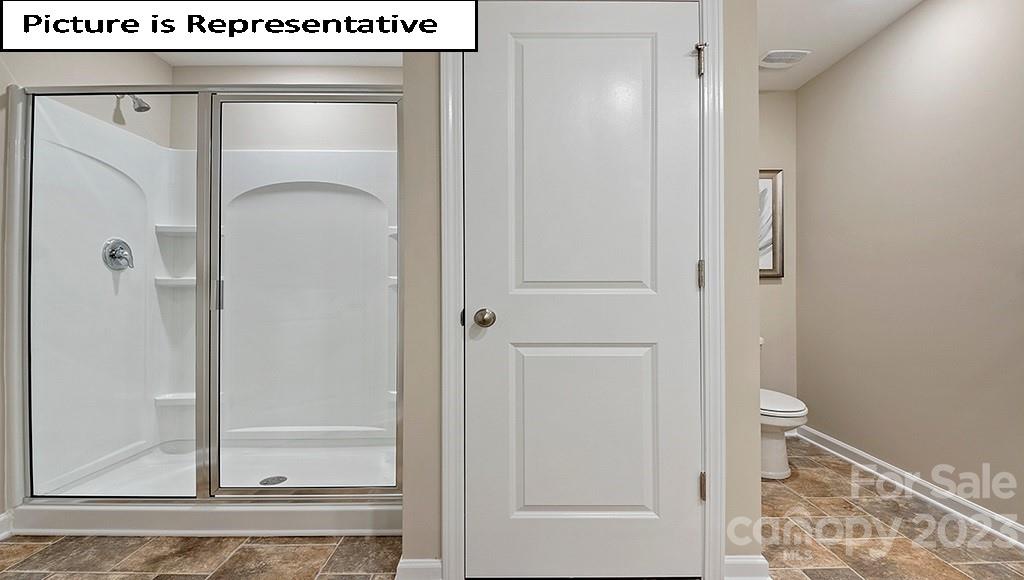 7113 North Mill Road Charlotte, NC 28216 - Photo 19 of 26 a bathroom with a glass door shower