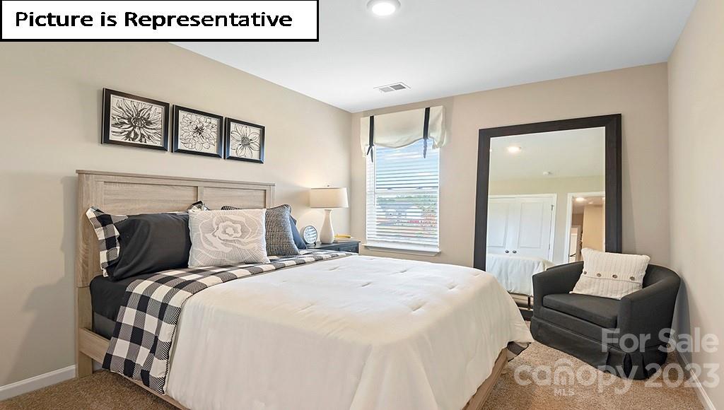 7113 North Mill Road Charlotte, NC 28216 - Photo 21 of 26 a bedroom with a bed and a painting on the wall