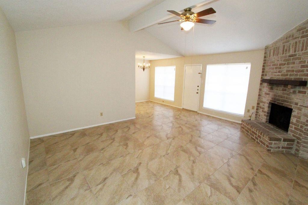 4627 Tealgate Drive Spring, TX 77373 - Photo 2 of 7 a view of empty room with a fireplace and fan