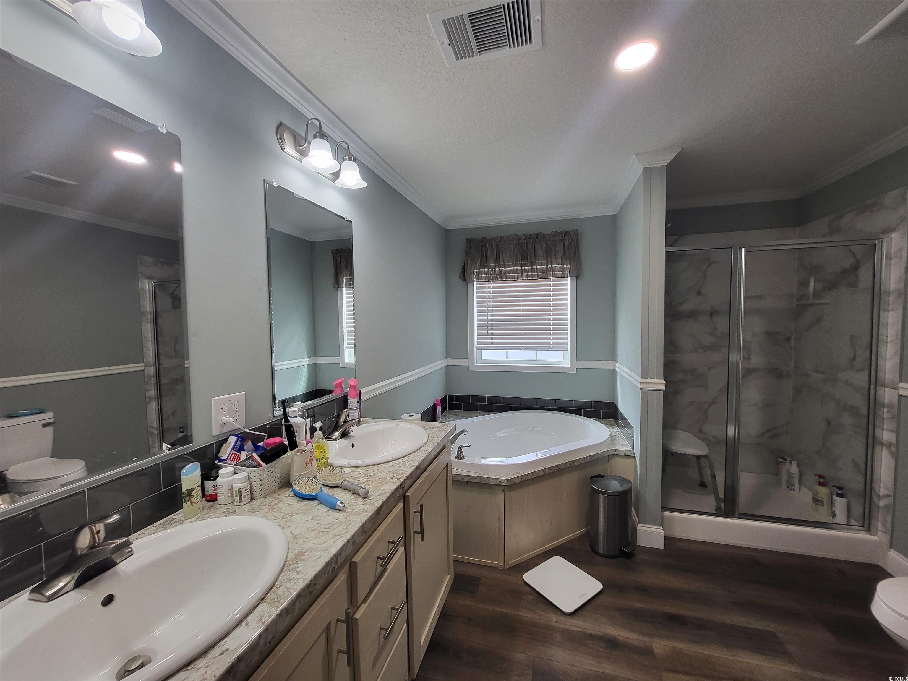 181 Offshore Drive Murrells Inlet, SC 29576 - Photo 12 of 28 Full bath featuring a marble finish shower, a garden tub, dark wood-style floors, double vanity, and a textured ceiling