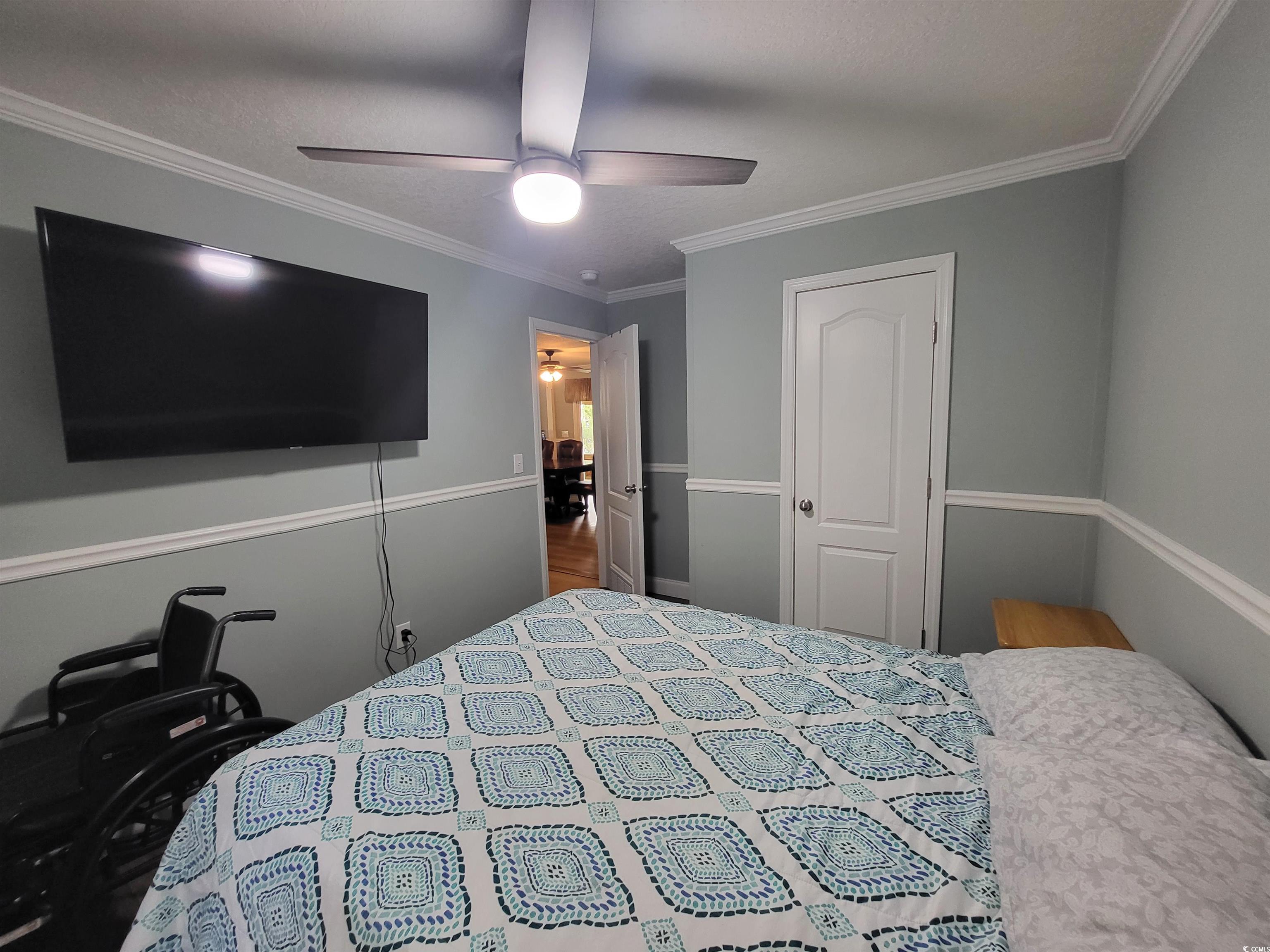 181 Offshore Drive Murrells Inlet, SC 29576 - Photo 15 of 28 Bedroom with crown molding and a ceiling fan