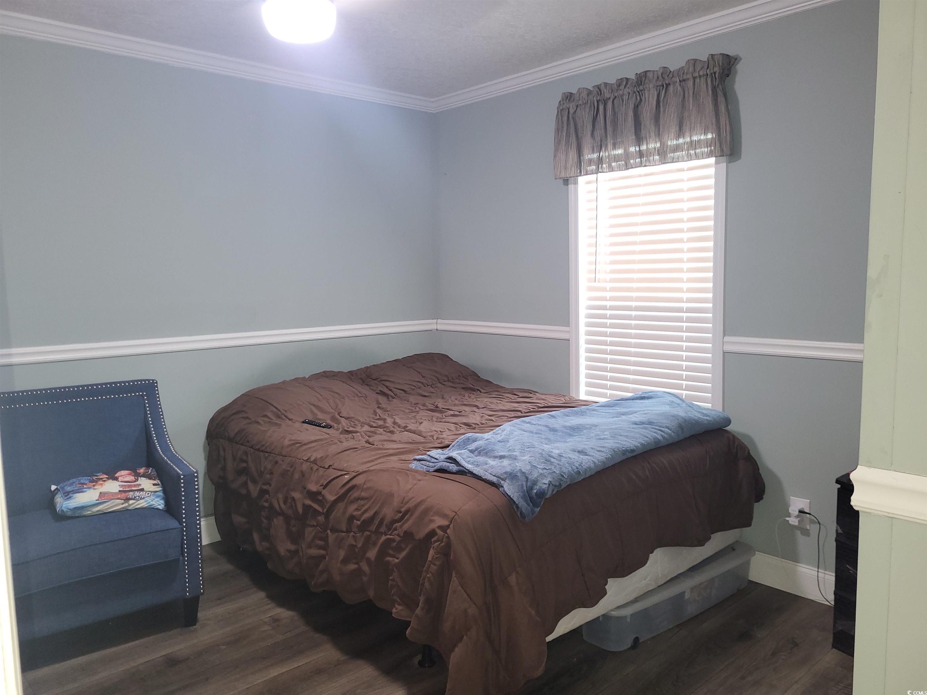 181 Offshore Drive Murrells Inlet, SC 29576 - Photo 18 of 28 Bedroom with dark wood-style flooring and ornamental molding