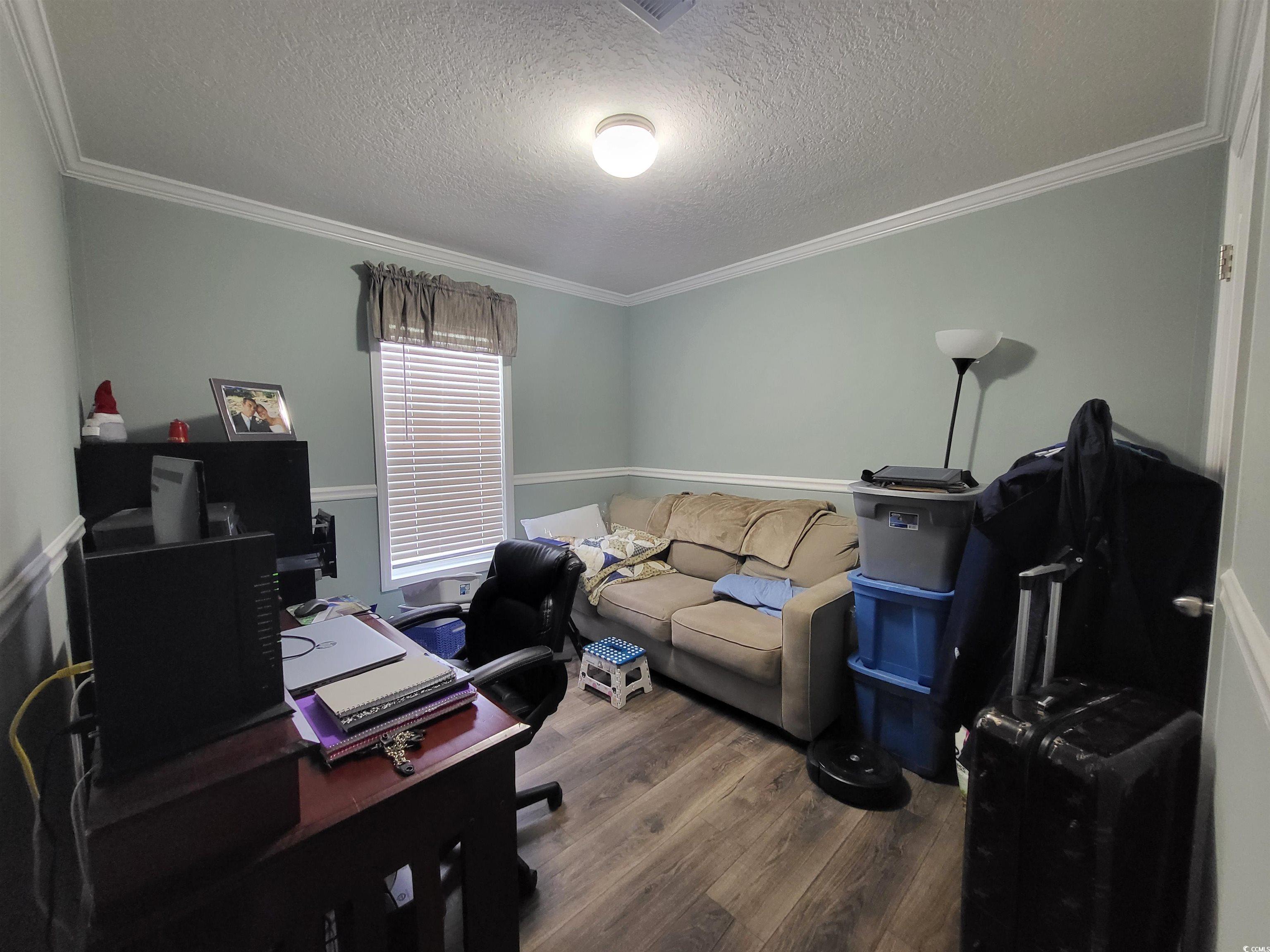 181 Offshore Drive Murrells Inlet, SC 29576 - Photo 19 of 28 Home office with dark wood-type flooring, a textured ceiling, and crown molding