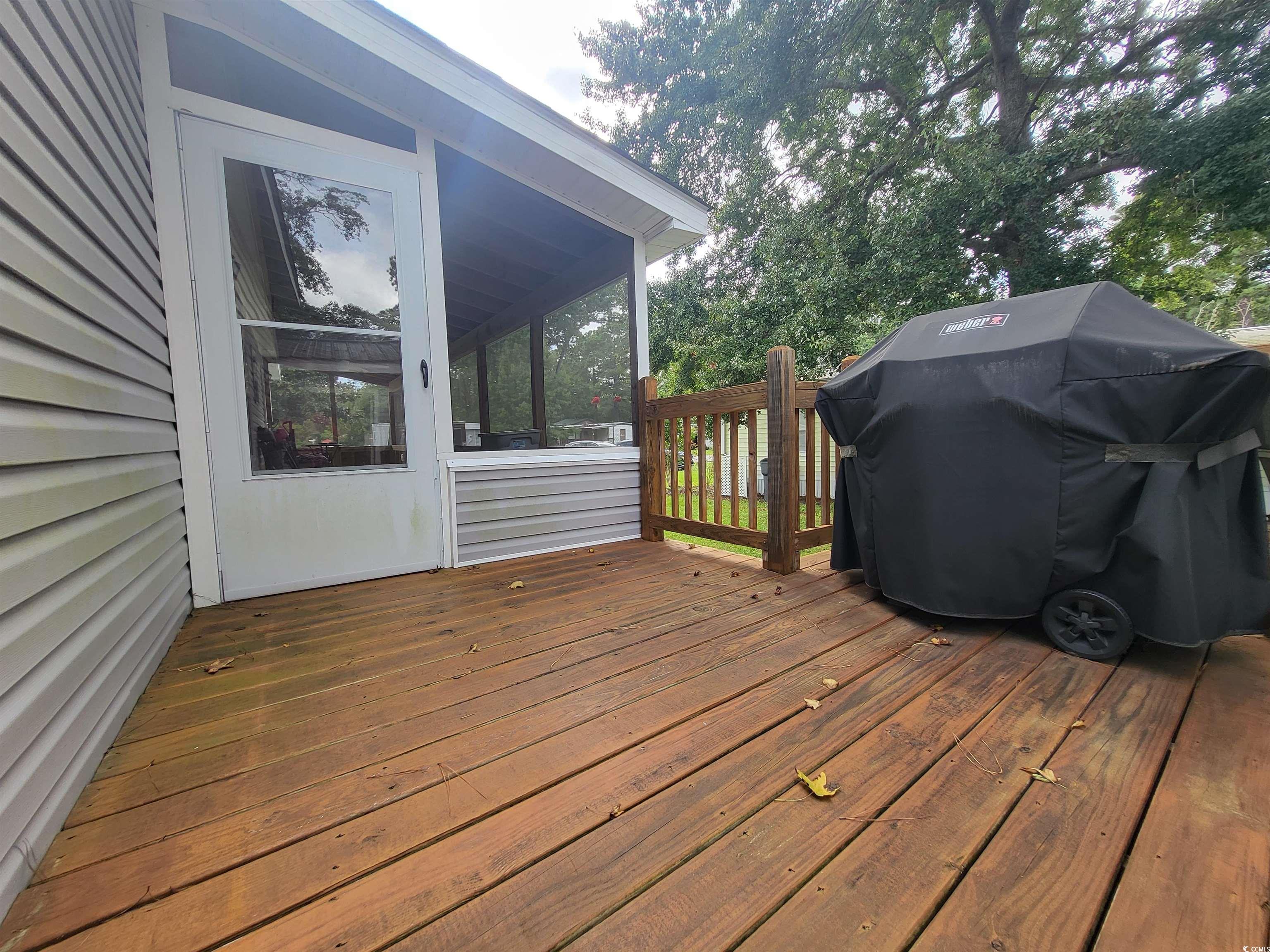 181 Offshore Drive Murrells Inlet, SC 29576 - Photo 23 of 28 Wooden deck featuring area for grilling and a sunroom