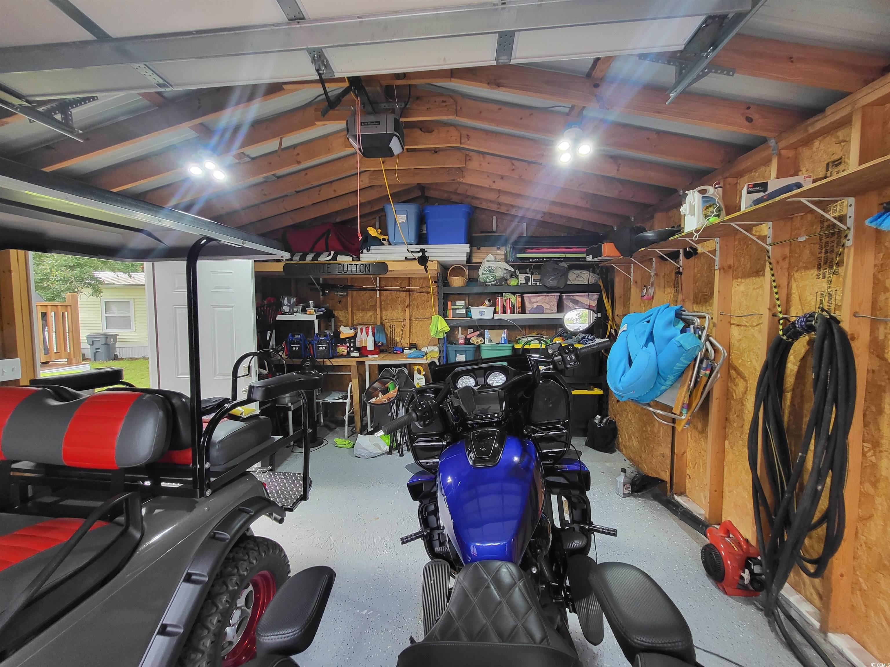 181 Offshore Drive Murrells Inlet, SC 29576 - Photo 25 of 28 Garage featuring a garage door opener and a workshop area