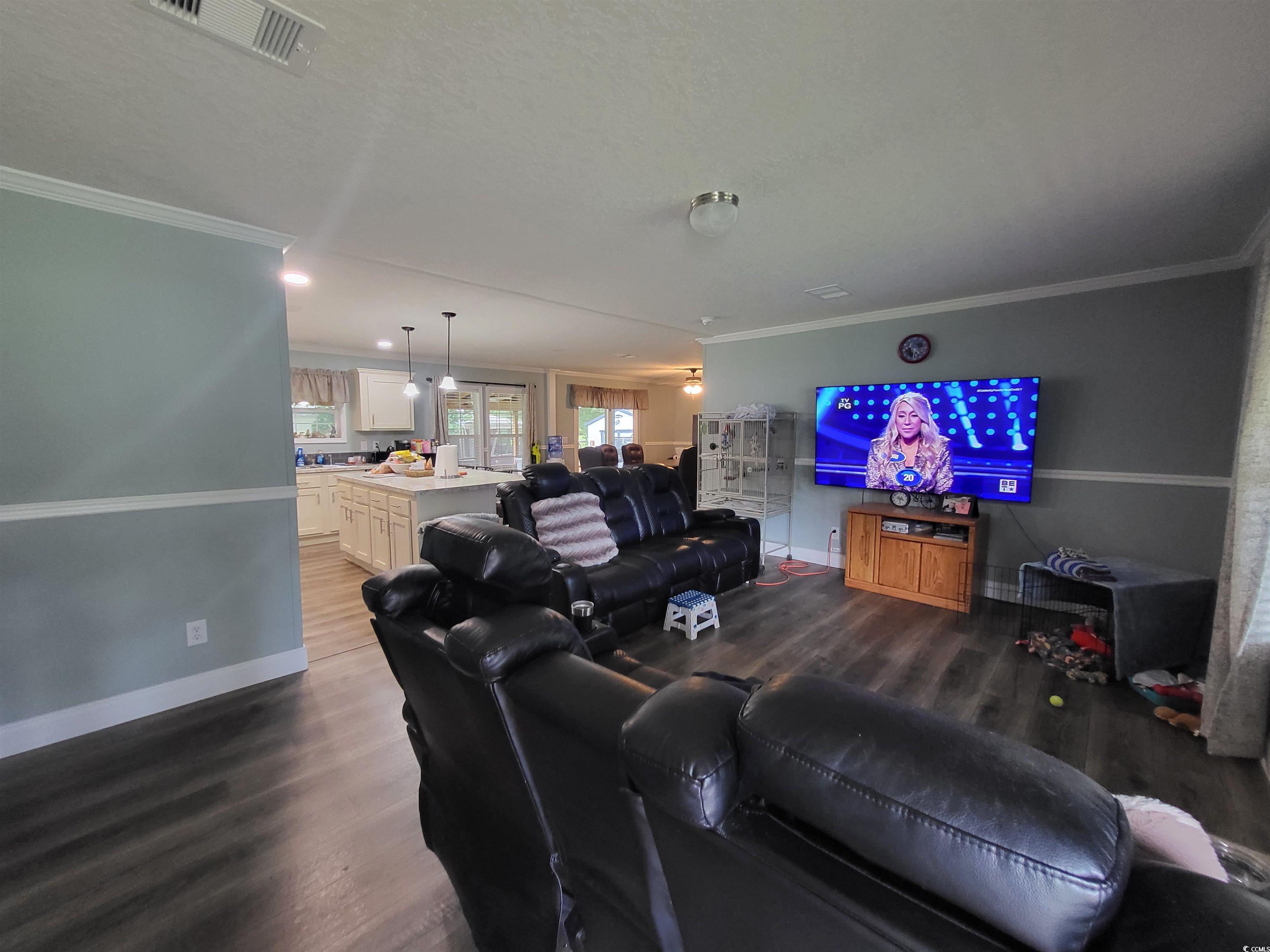 181 Offshore Drive Murrells Inlet, SC 29576 - Photo 6 of 28 Living area featuring ornamental molding, dark wood-type flooring, and recessed lighting