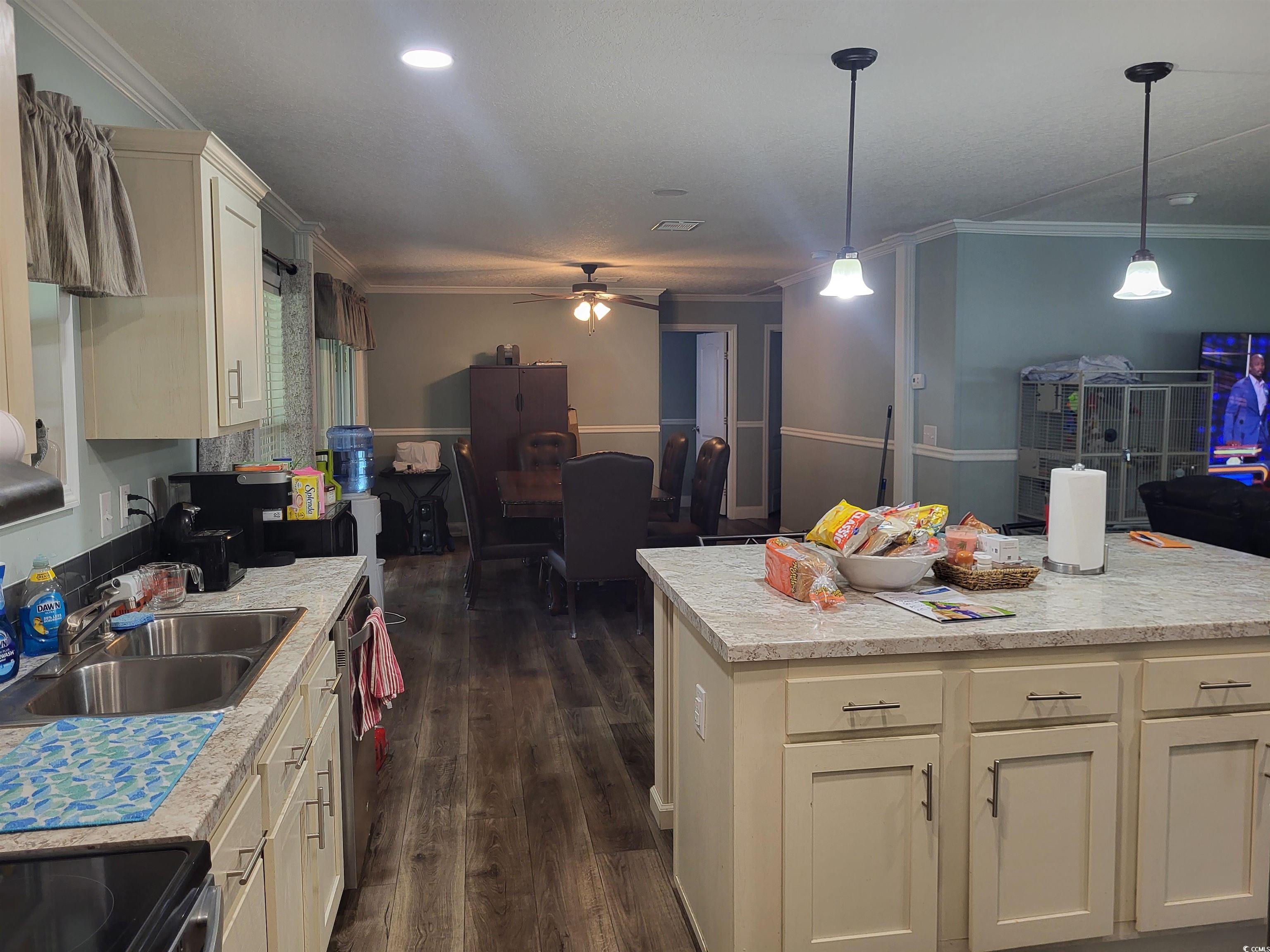 181 Offshore Drive Murrells Inlet, SC 29576 - Photo 27 of 28 Kitchen featuring ornamental molding, light countertops, a ceiling fan, dark wood-type flooring, and open floor plan